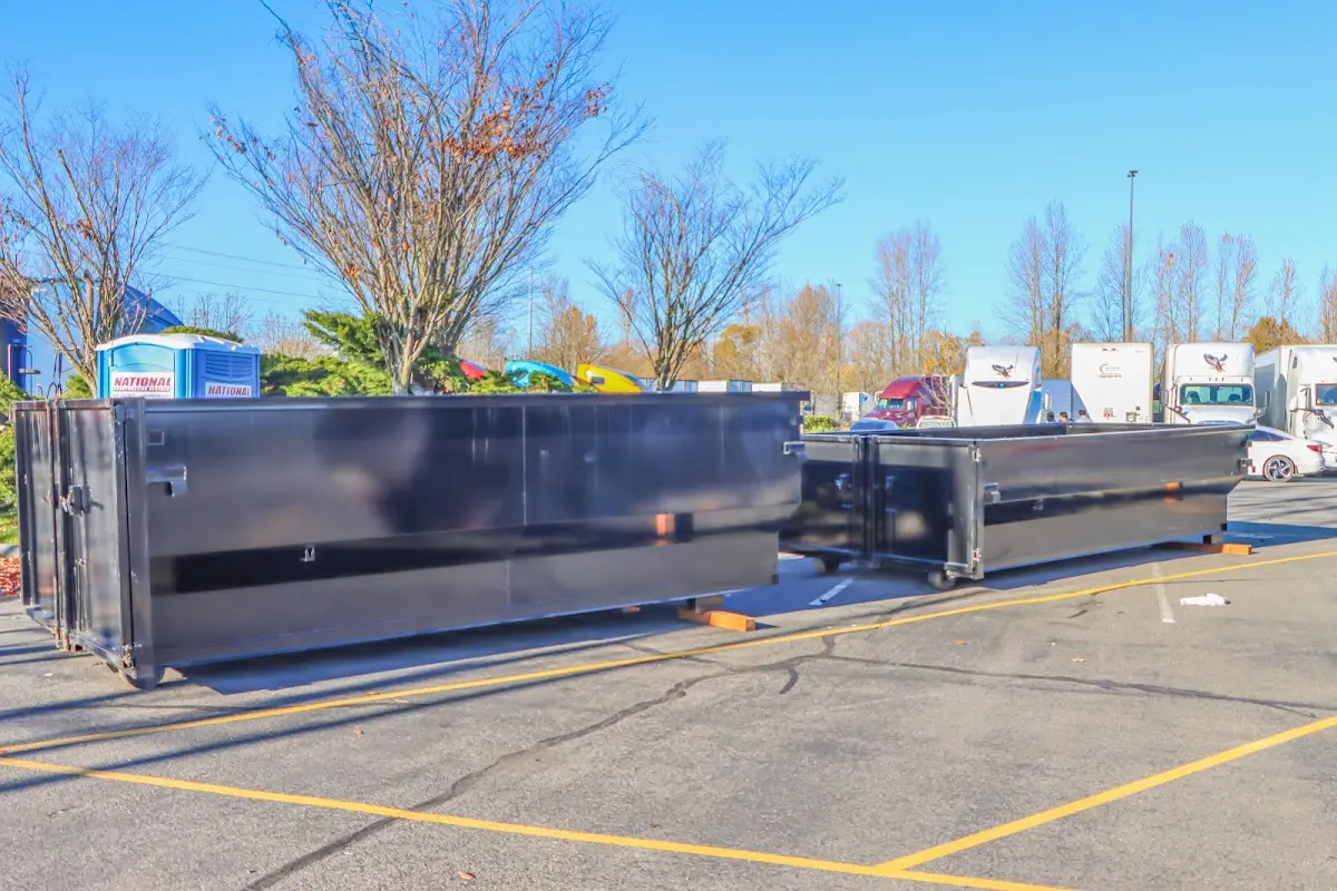 Professional dumpster rental service with roll-off container on residential driveway in Dyer